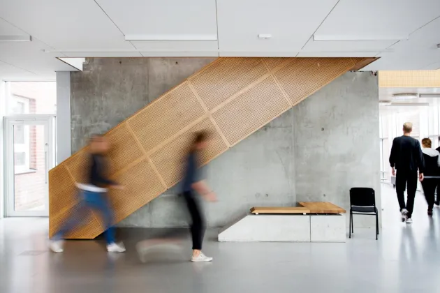 Students in motion blur in the M-Building. Photo. 