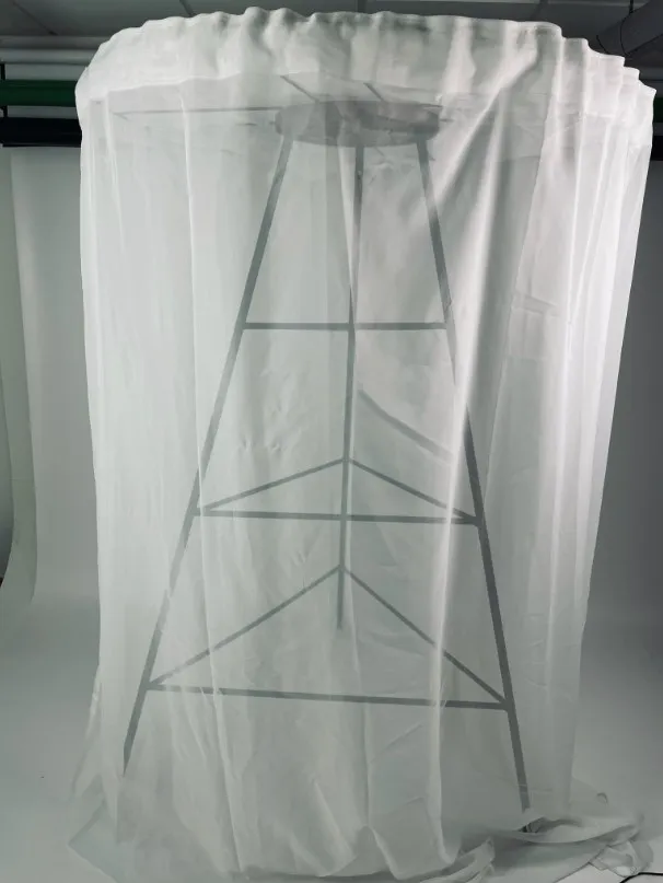 Metal lamp with white fabric. Photo. 
