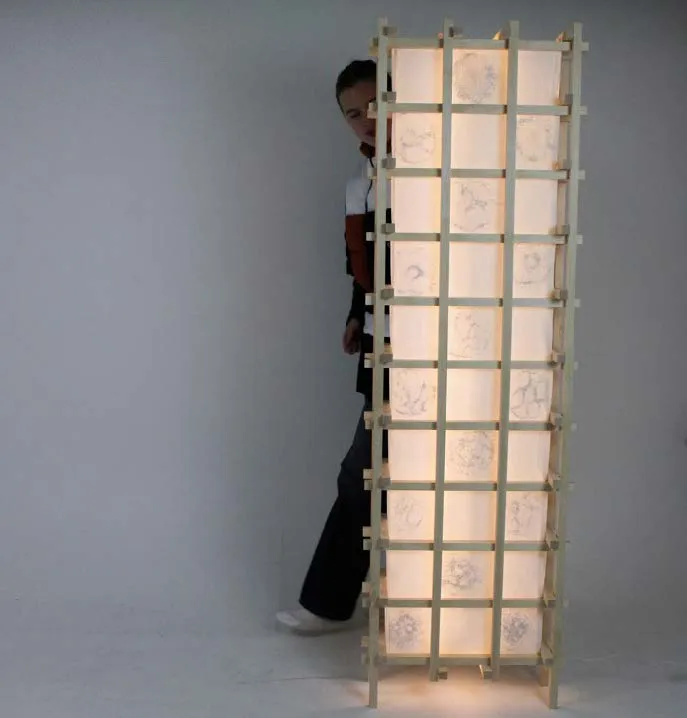 Man standing behind lamp. Photo.