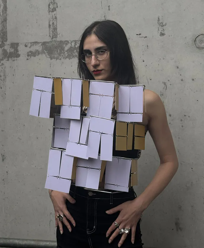 Woman wearing a paper construction. Photo.