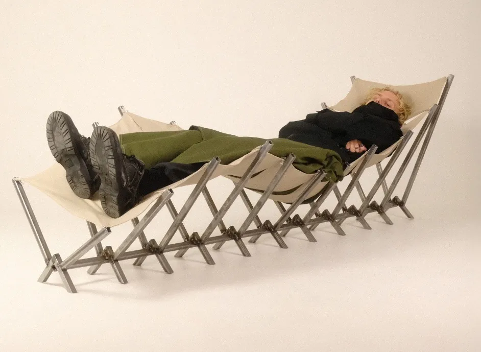 Man lying on expandable bench. Photo.