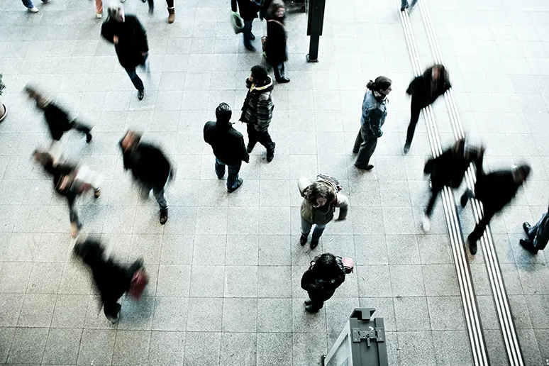People in motion walking in a square. Photo.