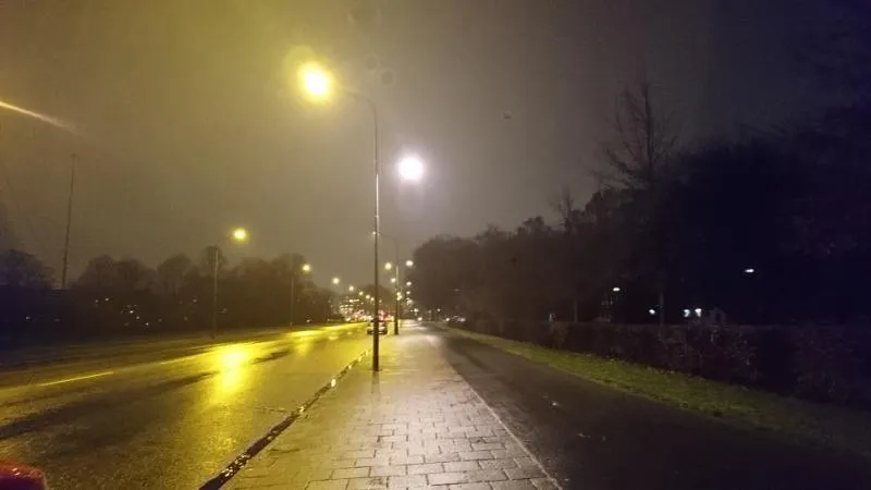 Dimly lit road at night. Photo.