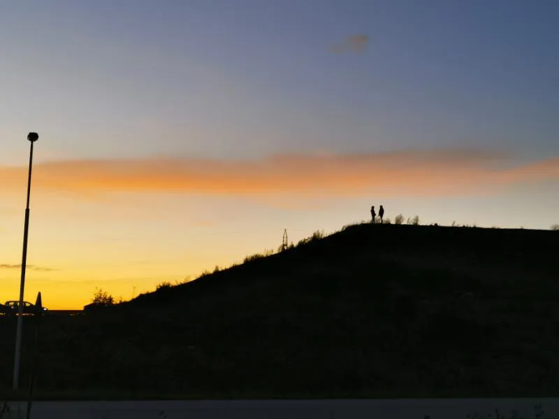 A dark hill at sunset. Photo.