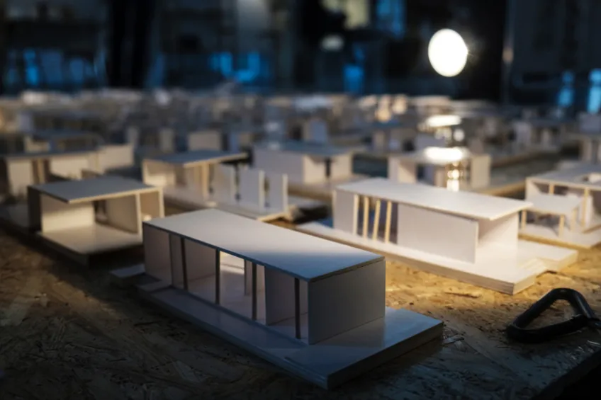 Cardboard models of buildings at student architectural exhibition. Photo.